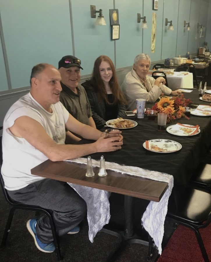 Nora eating with her father and his brother during the holidays at the restaurant. 
(photo courtesy of Nora Isblir) 