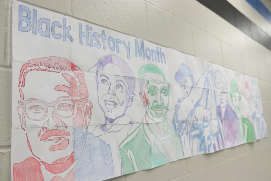 A banner created by members of Young, Gifted and Black displays prominent figures from history for students passing through B hallway.
