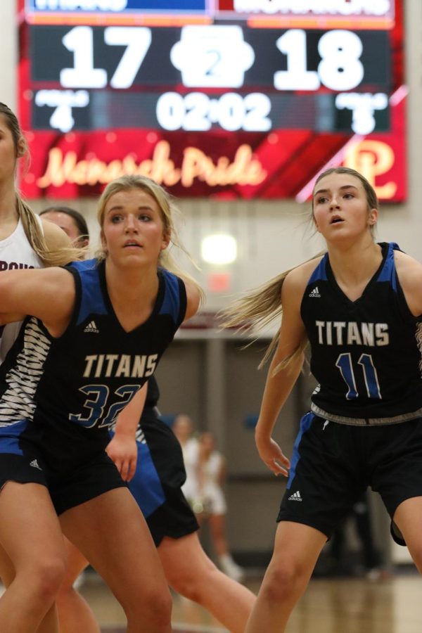 Kate Ligon, 11th and Ella Morehouse, 10th go for a rebound against the Monarchs. The Lady Titans were defeated in a close battle 39-32. 