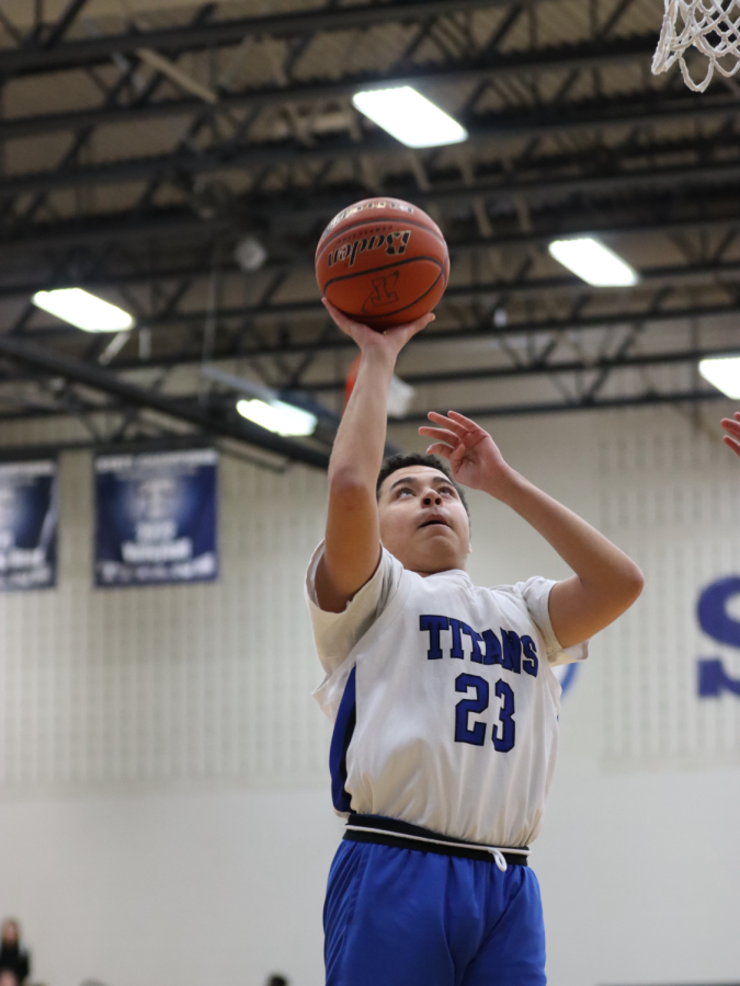 Keityn Slobodny, 12th, goes in for a layup in the Unified basketball game against Omaha Burke. Slobodny led the Titans in scoring with 12 points.