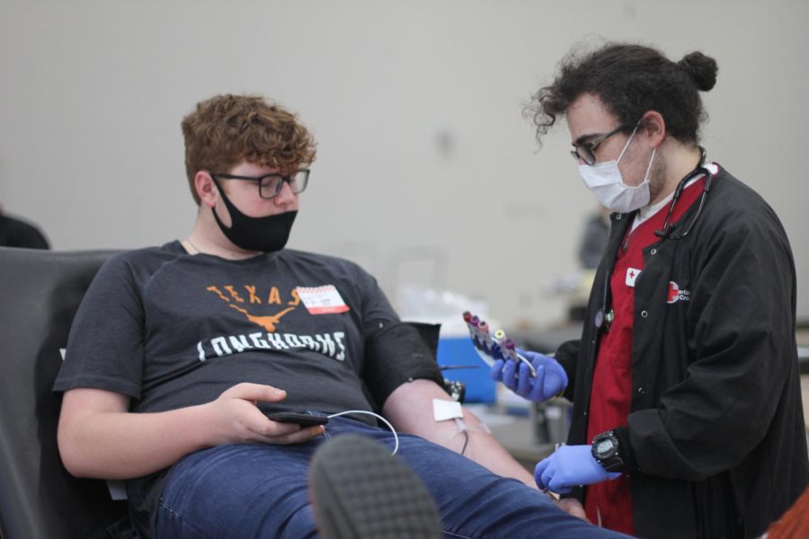 A student donating blood at a blood drive held by Papio South. 