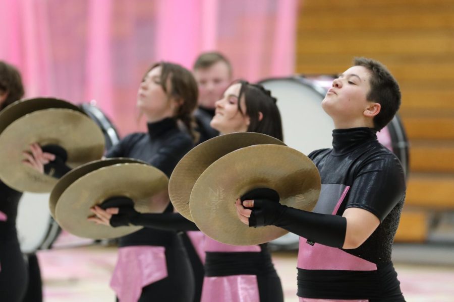 Cymbal line members Meredith Hill, 10th, Maelee Bruce, 10th, and Leo Duhs, 9th, 