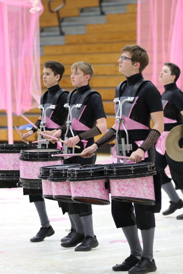 Landon Kirts, 12th, Cole Boyer, 11th, and Evan Redemske, 10th, have to maintain good posture while playing and carrying heavy equipment.