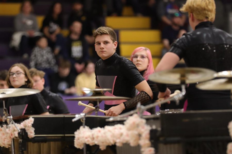 Ben Stearnes, 12th, performs with his fellow frontline members at their competition at Bellevue West high school. 