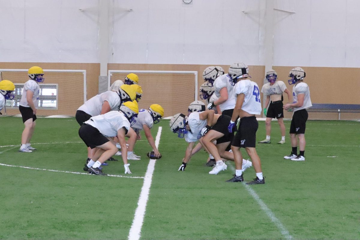 Titan football team lines up ready to snap the ball during indoor practice at Papillion Landing on Aug. 23. Dangerously high temps drove many teams indoors this week.