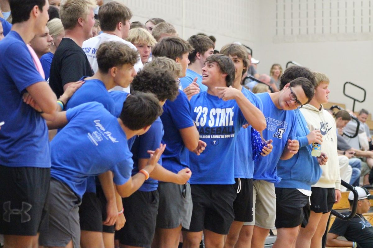 Black Hole leaders discuss what chant to do next during District basketball. 