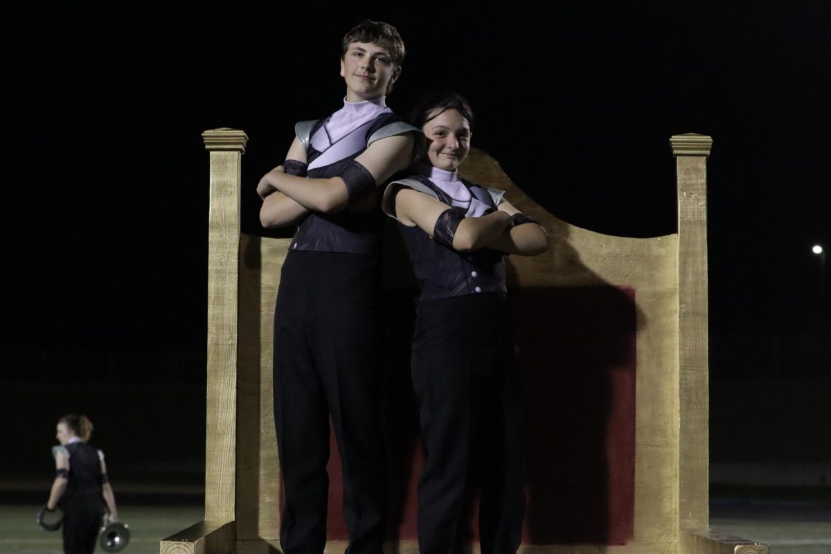 Clarinet members Jakob Deja and Gabbie Frost, both 10th, pose on top of cat throne after Community NIght performance. 