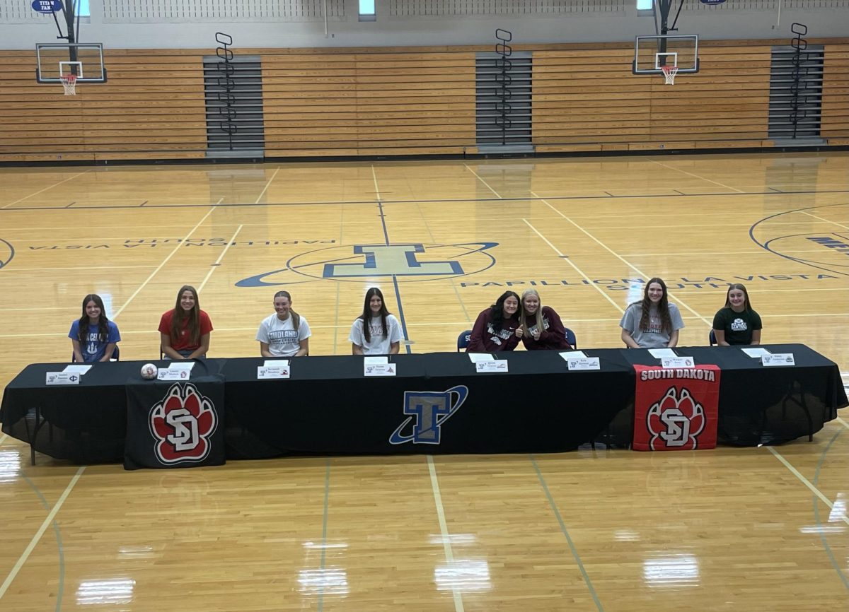 Left to right: Anabel Seaman, Lauren Medeck, Savannah Meadows, Emma Grzywa, Quinn Groves, Kyla Dyrstad, Morgan Bode, and Haley Anderson prepare to sign their letters of intent.