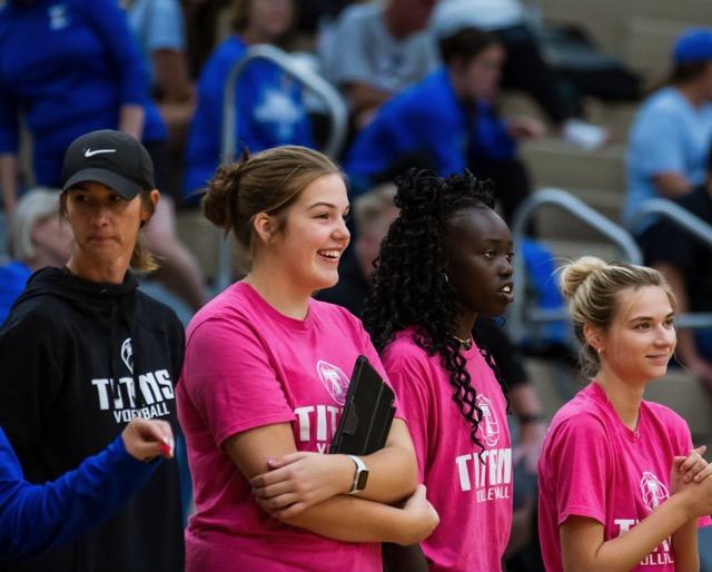 Team managers Taylor Parrack, 10th, and Rebekka Dang, 12th, join Coach Katie Tarman on the sidelines