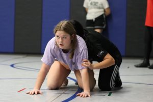 Allie Grow positions herself to learn in the 2022 inaugural season of Girls Wrestling. Grow will return to the team this year as a captain.