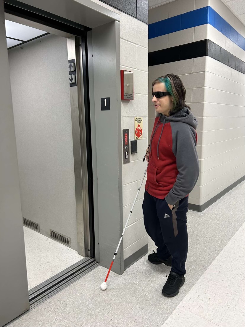 Senior Riley Tuzzio, who has a vision impairment, uses the elevator to reach upstairs classes.