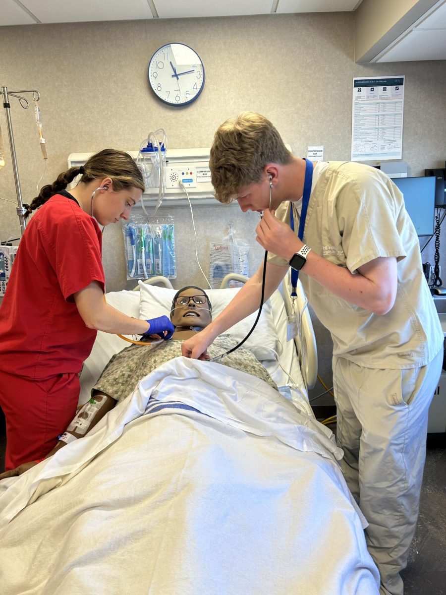 Kendall Schoening and Oliver Lambrecht, 12th, testing out a simulation dummy at Bryan Medical Center.