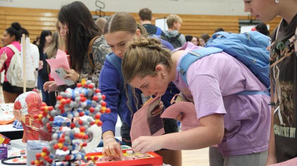 Senior Kinsey Lathrop plays operation as a short activity held at booth.