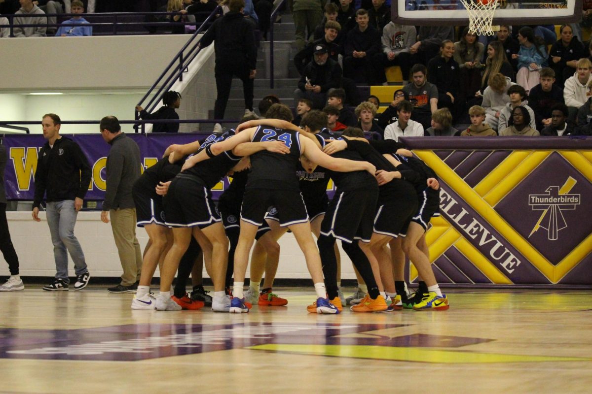 The boys basketball team in a huddle during the Metro tournament. 