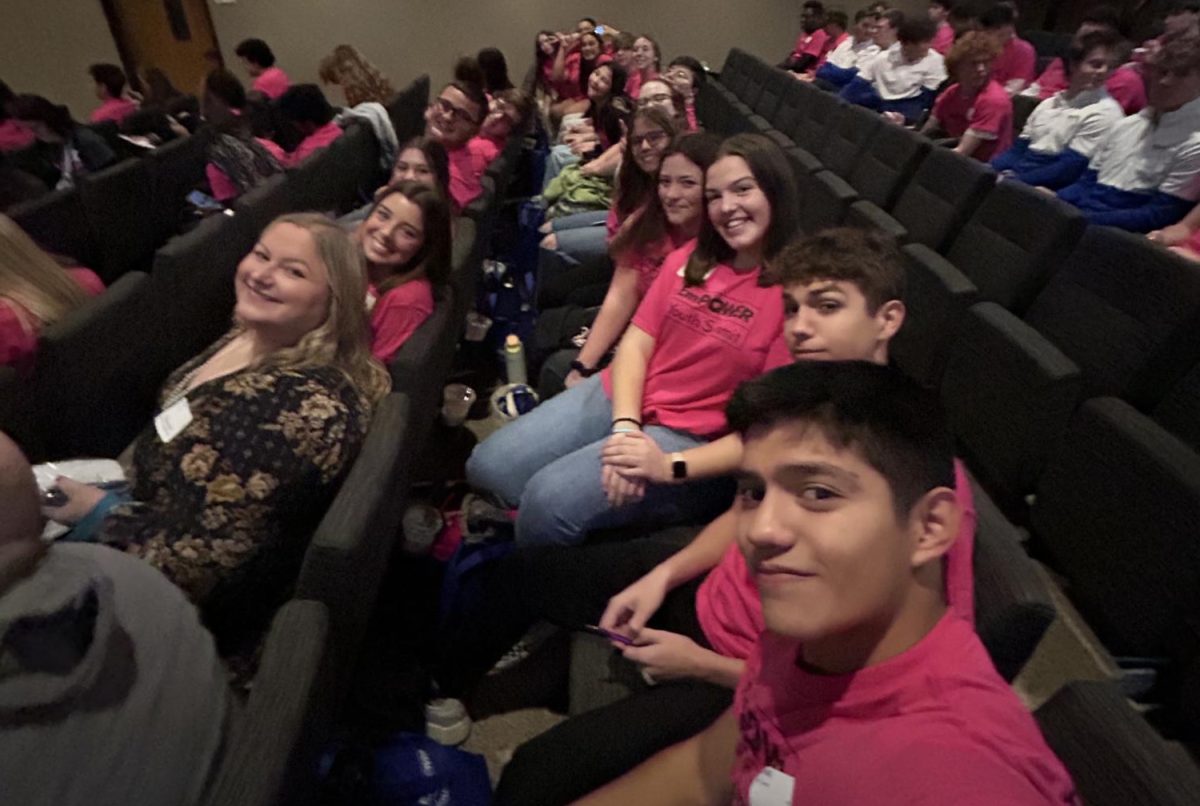 Hope Squad sponsor Allison Andersen in the front row, and Hope Squad member Taylor Parrack, in the second row, both sit at the center of the group at the EmPower Youth Summit, awaiting the guest speaker.  