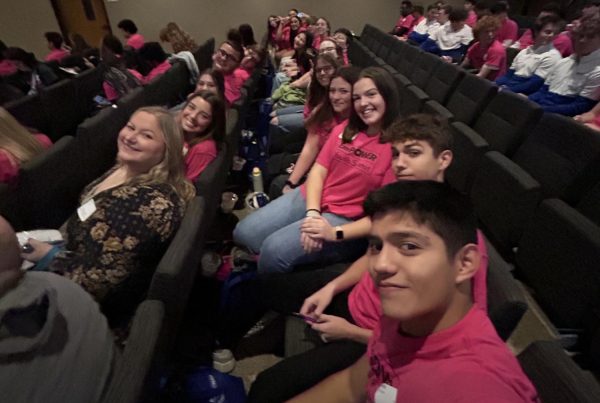 Hope Squad sponsor Allison Andersen in the front row, and Hope Squad member Taylor Parrack, in the second row, both sit at the center of the group at the EmPower Youth Summit, awaiting the guest speaker.  