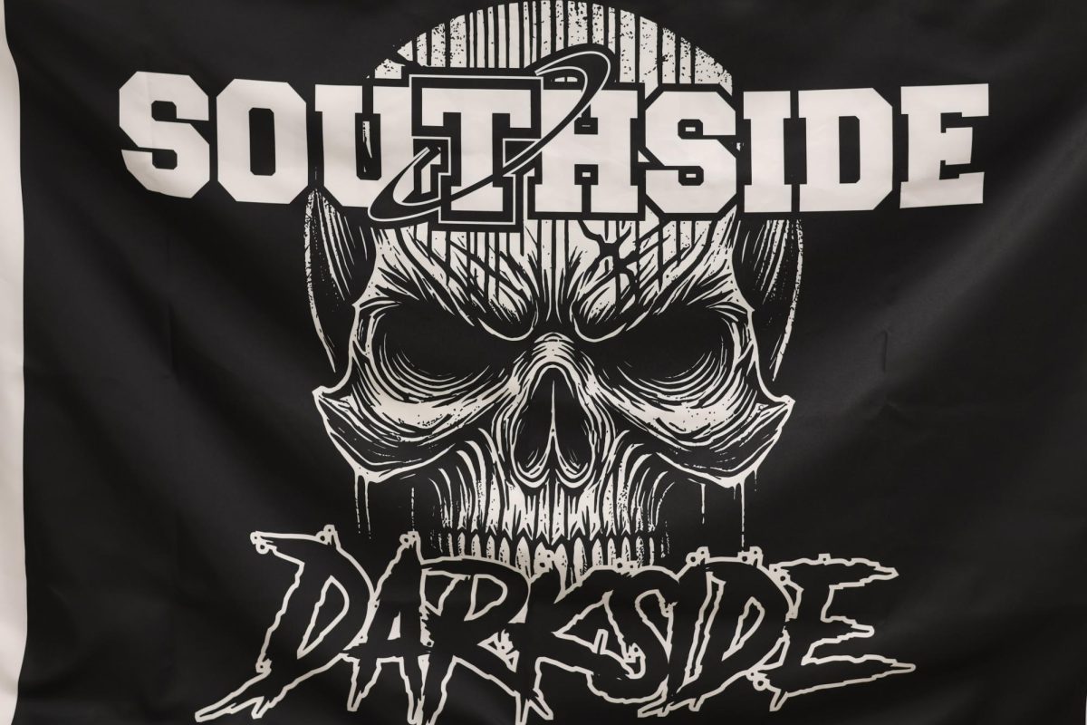 The Darkside unfurls a new flag to be flown on the field this year.