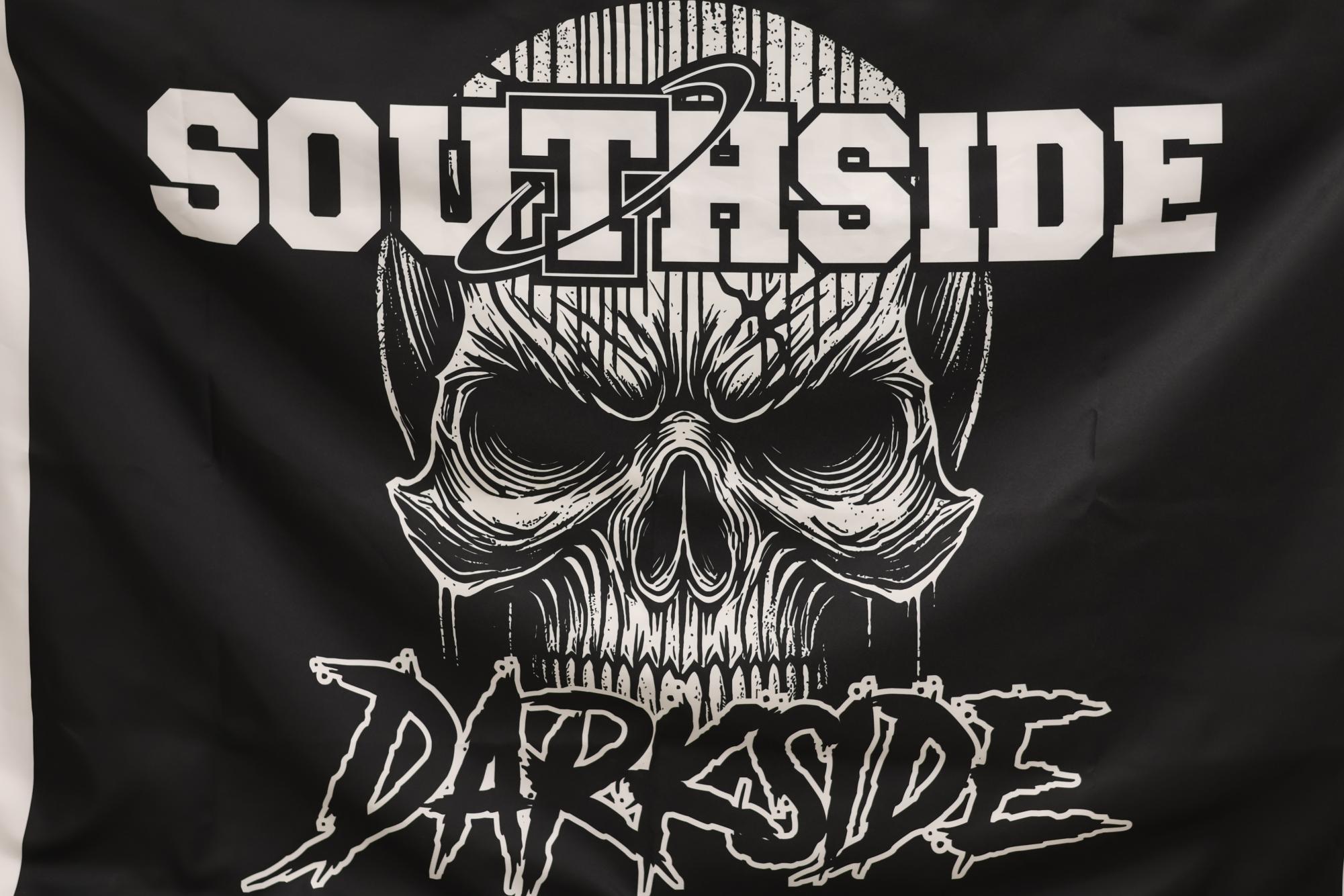 The Darkside unfurls a new flag to be flown on the field this year.