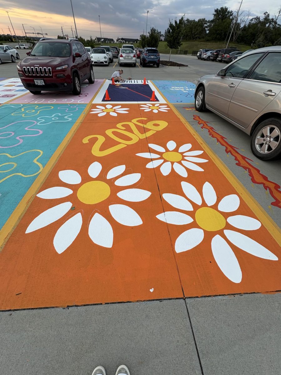 "My moms best friend recently died of cancer so I chose daisies which were here favorite to honor her. Then orange is my favorite color. There is also a white thumbprint heart that I did with my best friend Liv."