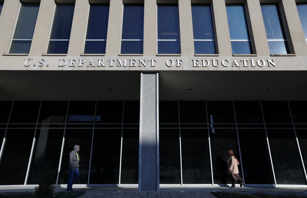 People walk in front of the Department of Education building, amid reports that U.S. President Donald Trump's administration will take steps to defund the federal Education Department, in Washington, U.S., February 4, 2025. REUTERS/Kevin Lamarque