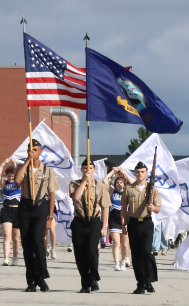 Cadets Joel Akin-Otiko, DJ Adams and Titus Pummer displaying the colors as they lead the Homecoming Parade.  