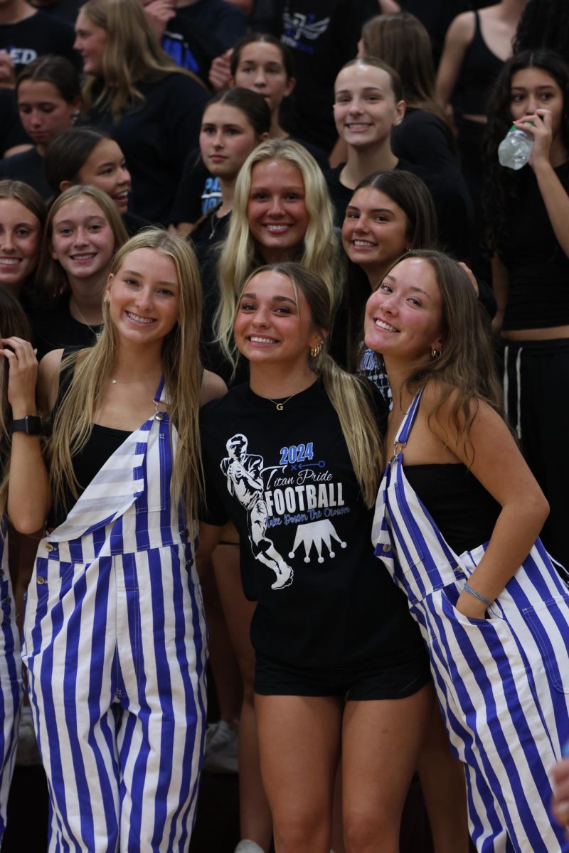 Seniors Alyssa Dierks, Grace Dahlke, and Kendall Lawrence in Black Hole at Titan-Monarch volleyball game. 
