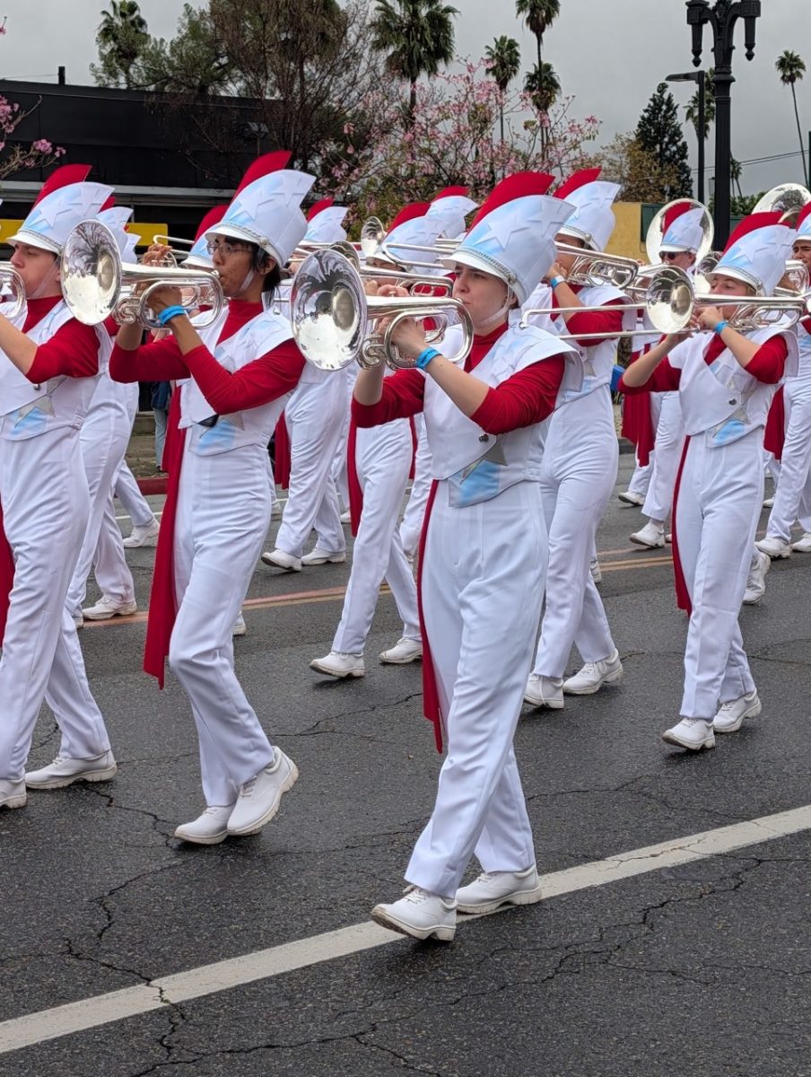 The members of the Honor Band, a band made up of students from all over the country, parade through the rainy streets of Pasadena, California on New Year’s Day.