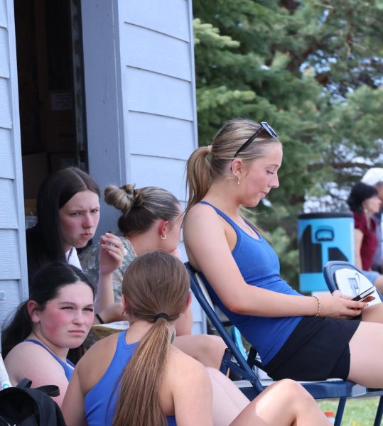 JV Tennis players Olivia Noble, Kinsley Bowers, and Charlotte Hartnett take a break from a busy tennis match.