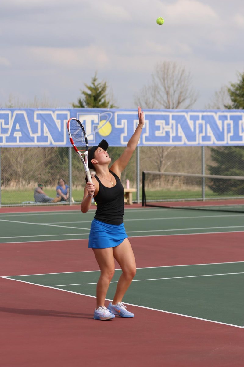Senior Kendall Lawrence prepares to take a swing at the service line.